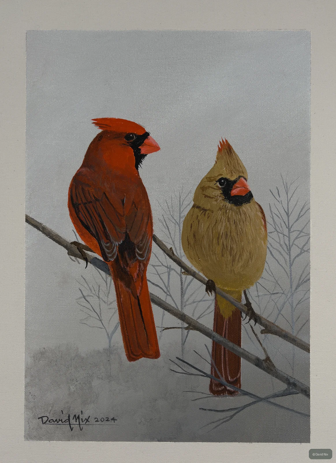 Male and female cardinals on bare winter branch.